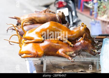 Dog meat sold at market in Hanoi, Vietnam - Stock Photo