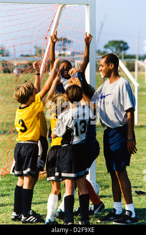 Kids soccer team, girls and boys together, with coach teaching skills, teamwork, teamspirit, Melbourne, Florida - Stock Photo